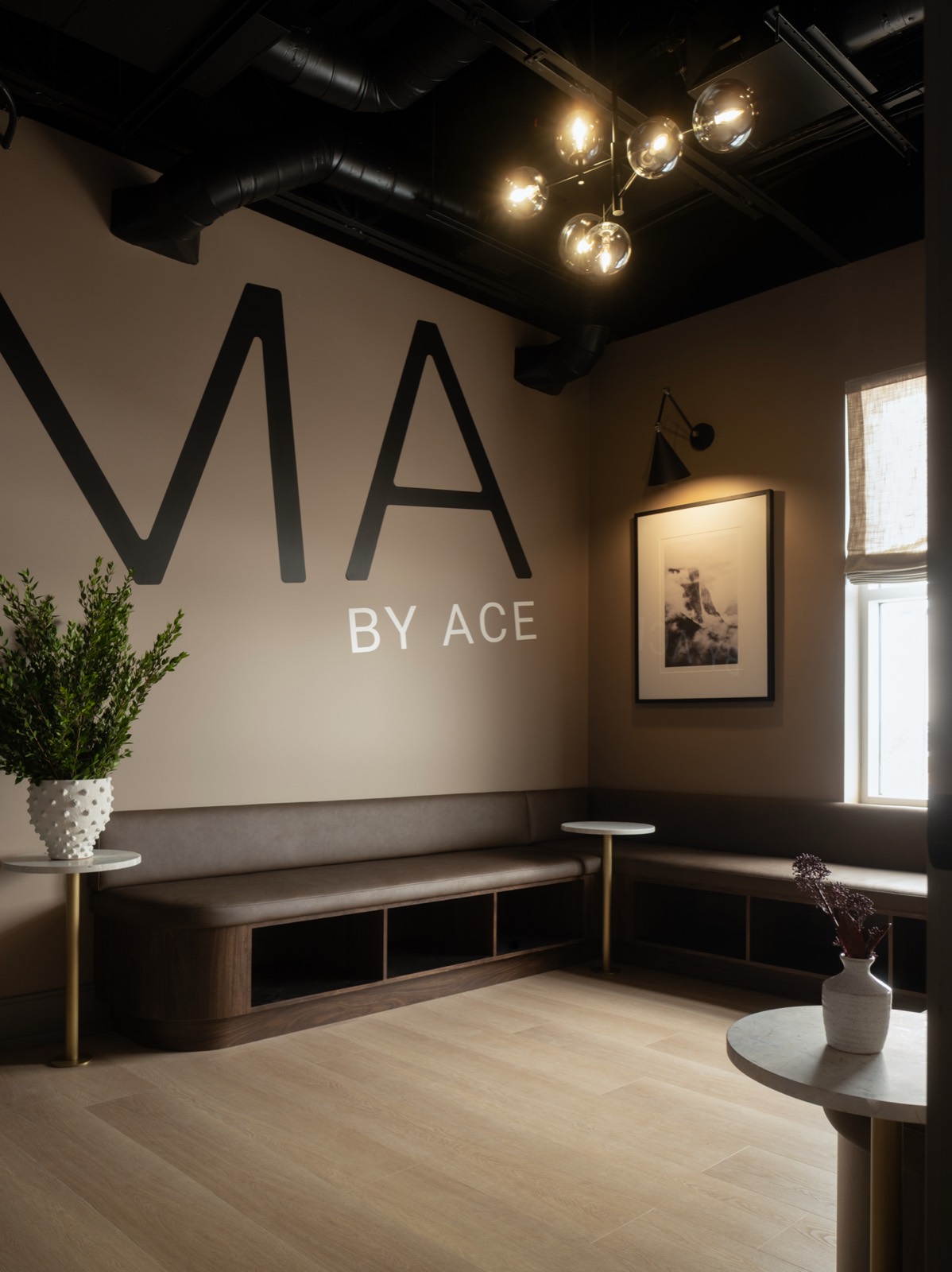 Forma lounge with bench seating, plants, and the Forma by ACE wall lettering