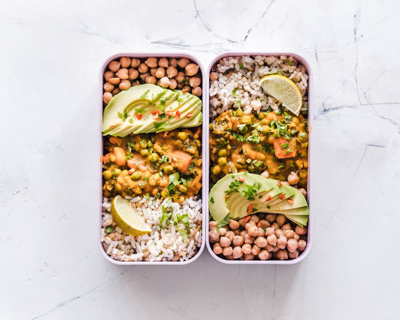 Meal prep containers with rice, chickpeas, and avocado
